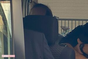 アパートの実況見分を終えて警察車両の後部に乗せられた宮哲夫容疑者の頭部（中央）