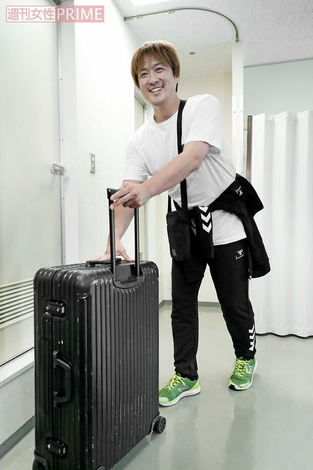 「すみません」と酒井は、会場に持ち込んだキャリーバッグを手にこれから公演へ　撮影／佐藤靖彦