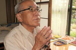 仏壇に手を合わせる南一成さん。表情が引き締まる