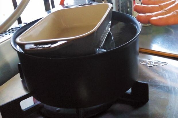 肉が浮いて湯から出ないように、皿などで重しをする