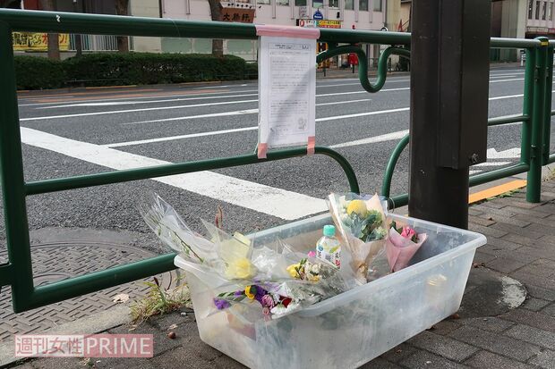 事故現場に貼られた松永さんの文章の下にはお供えものが