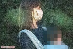 幼い子どもを抱えながら住宅街を歩く小倉優子