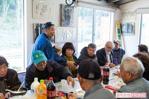 来客におにぎりを配って回る濱田