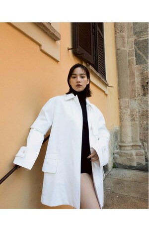 超ミニ丈のインナーに白のコートを羽織った姿を披露した、のん(公式ブログより)