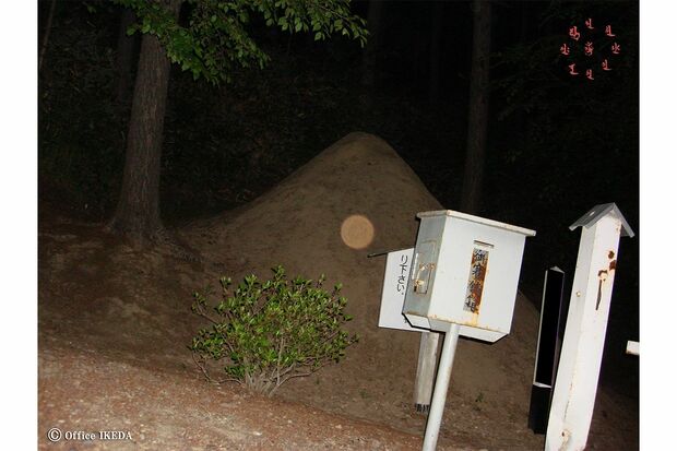 鎖塚で撮った一枚。土饅頭の上に赤いオーブ（霊魂）が写った。赤い色は成仏できぬ、地縛霊の怒りを表す（※掲載している心霊写真はすべて除霊済みです）（写真提供／池田武央）