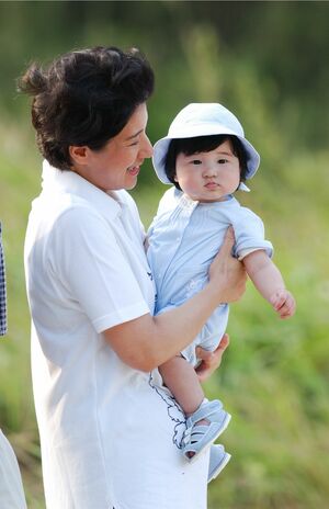 '02年8月(8か月)須崎御用邸で。ロンパースにはうさぎの刺しゅう。帽子、靴までそろったワントーンコーデが可愛くもシック(撮影/JMPA)