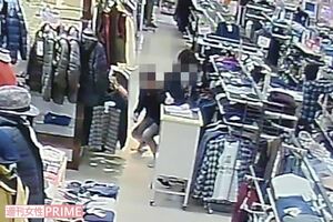 Aが盗撮する現場をとらえた防犯カメラの画像。不自然にかがみながら左ポケットからスマホを出し、女性従業員のスカートの中を狙っている（読者提供）