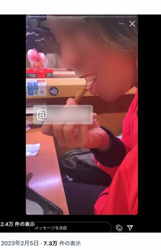 『スシロー』にて、レーン上の注文商品のパフェの菓子を食べる若い男性