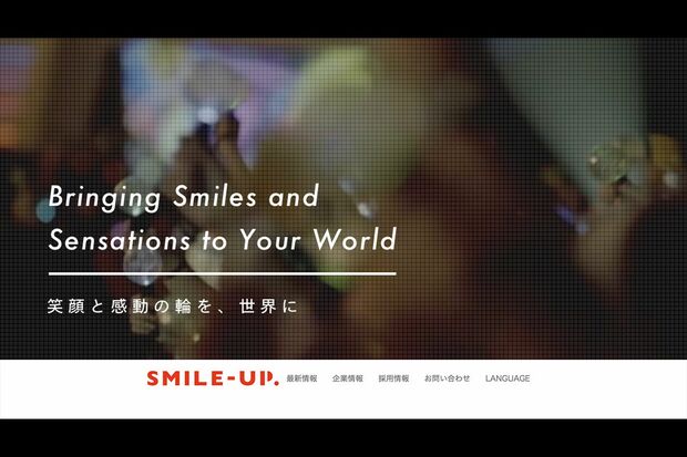 スマイルアップ公式サイトのトップ。批判を集めた「笑顔と感動の輪を、世界に」