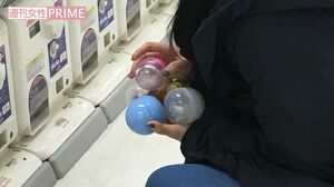 両手いっぱいにガチャを爆買いした女性