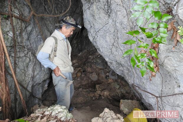 暗いガマの中で土を丁寧に取り除き、遺骨を掘り起こす。この作業を約40年続けてきた　撮影／渡瀬夏彦
